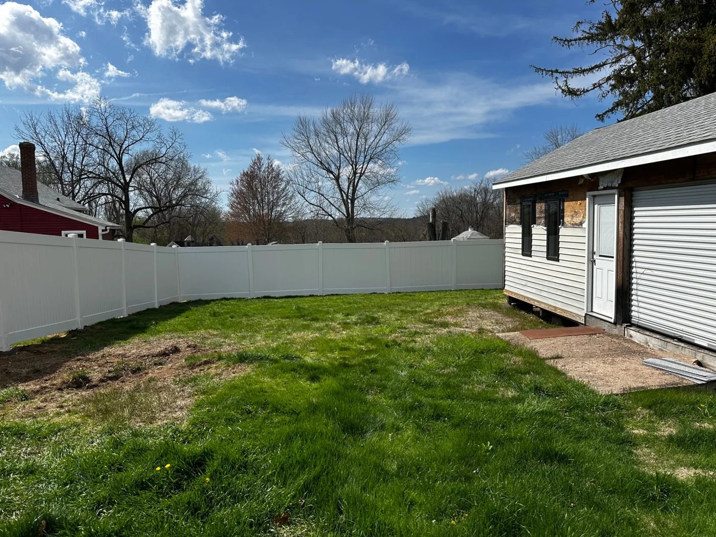 White vinyl privacy fence enclosing backyard