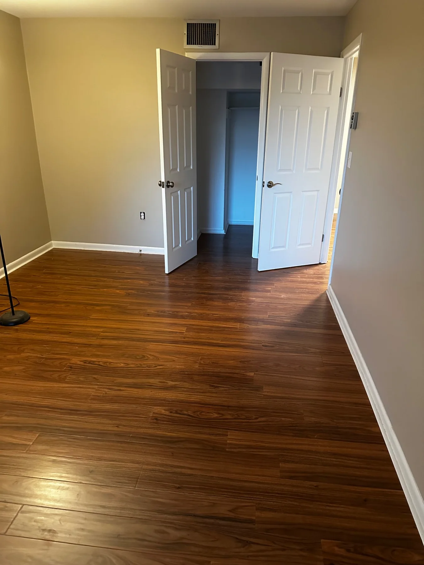 Completed LVP flooring in bedroom with closet